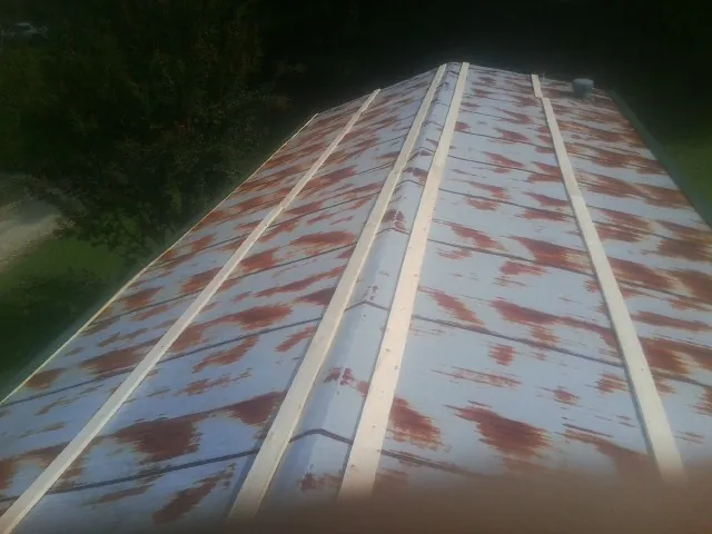 Rusted metal roof panels with new wood purlins before replacement — Storm Damage Roof Repair in Irmo by Roofing Brothers