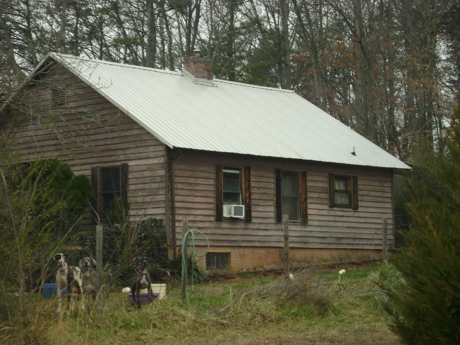 White metal roof on an old wood sided farmhouse, from a Metal Roof Installation job in Irmo